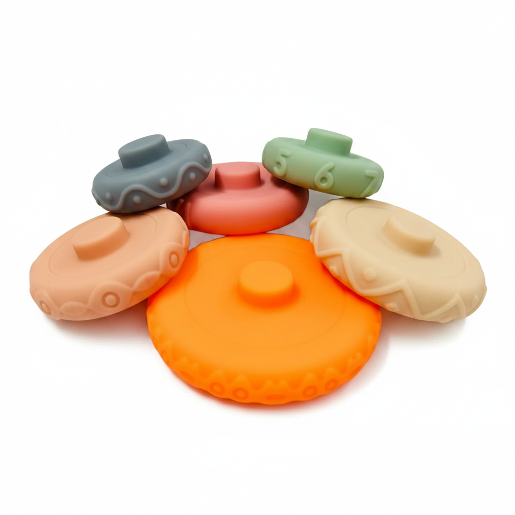 6 individual silicone stacking ring pieces spread out - pastel colors