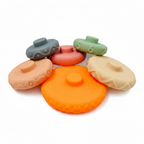 6 individual silicone stacking ring pieces spread out - pastel colors